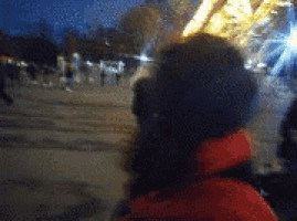 a person is taking a picture of a crowd of people at night