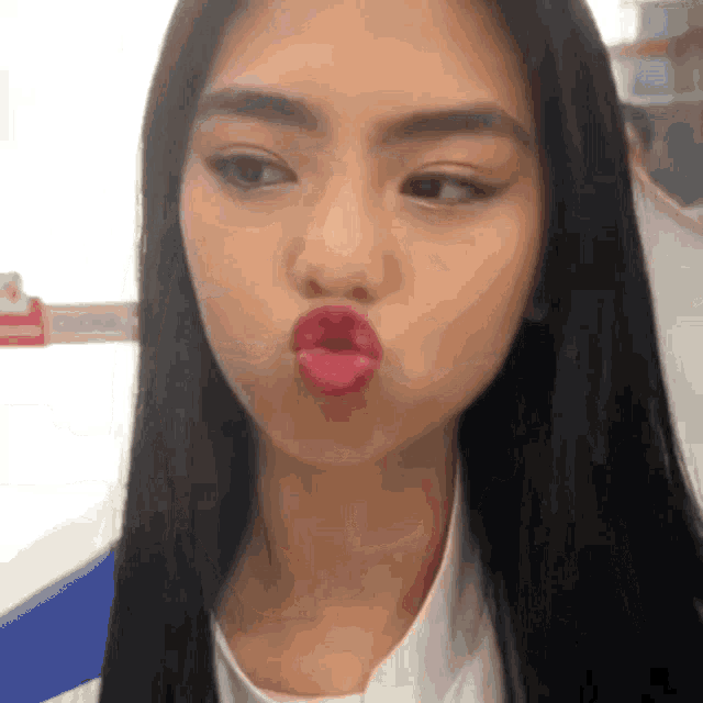 a woman with long black hair making a funny face with her mouth open