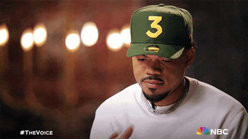 a man wearing a green hat with the number three on it