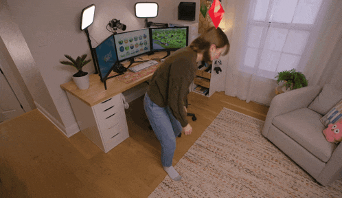 a woman is standing in front of a desk with a computer monitor that says ' minecraft ' on it