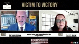 a man in a suit and tie is talking to a woman in glasses on a video call .