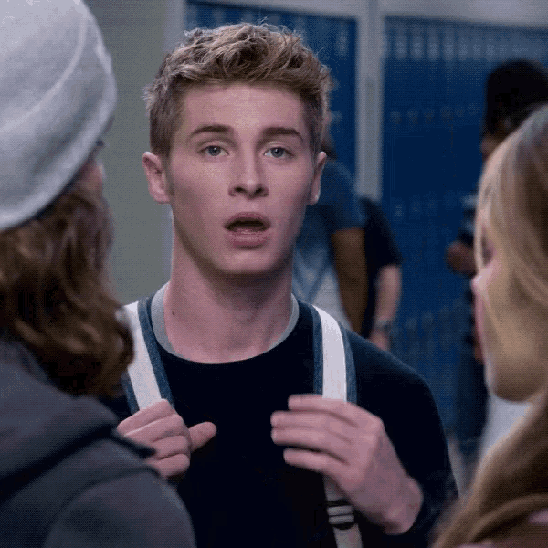 a man with a backpack is talking to another man