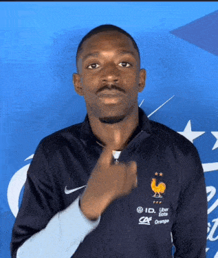 a man wearing a nike jacket with a rooster on the front