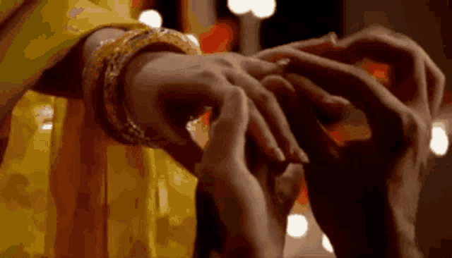 a man is putting a wedding ring on the finger of a woman .