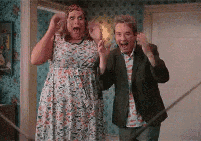 a man and a woman are standing next to each other in a room and dancing .