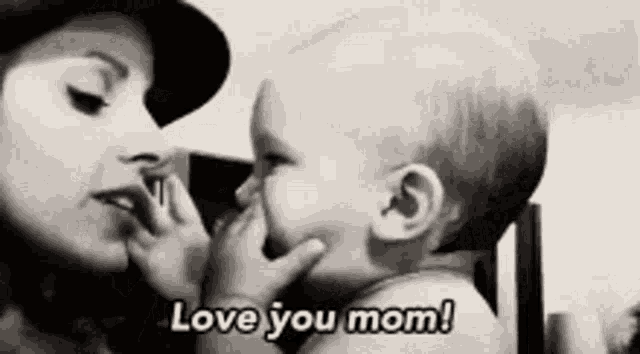 a black and white photo of a woman holding a baby and saying `` love you mom ! ''