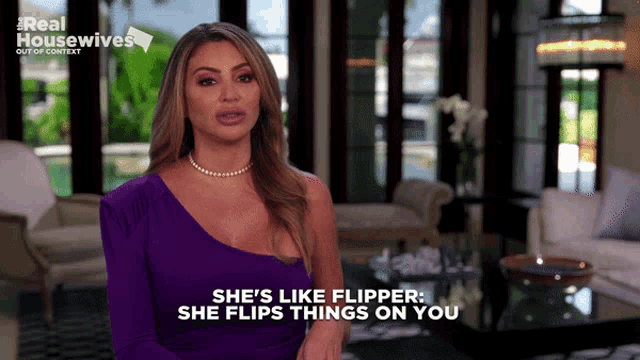 a woman in a purple dress says she 's like flipper and flips things on you