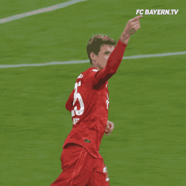 a soccer player wearing a red jersey with the number 25 on it