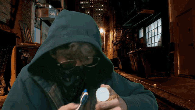 a man in a hooded sweatshirt is brushing his teeth with a toothbrush in front of the word today 's