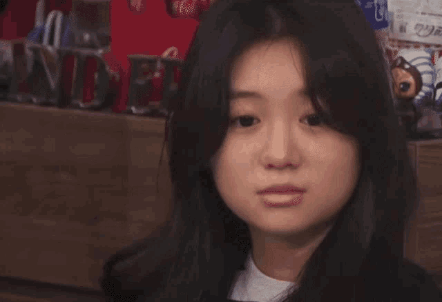 a close up of a young woman 's face with a serious look on her face .