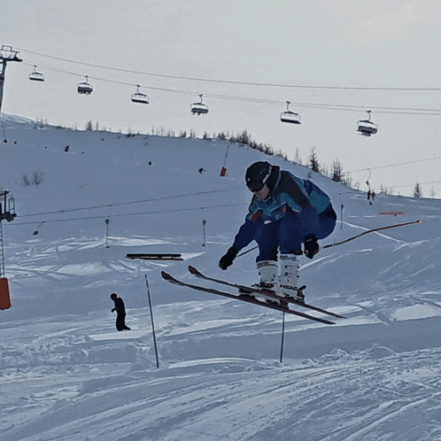 a skier wearing a pair of head ski boots is doing a trick in the air