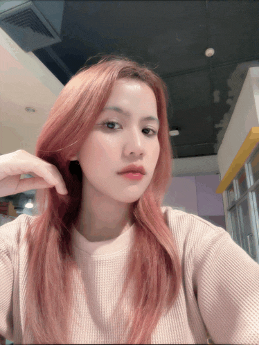 a girl with long red hair takes a selfie