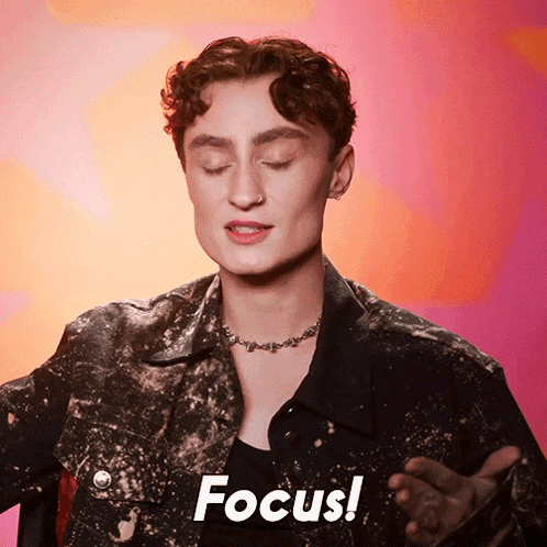 a man in a black jacket says " focus " on a pink background