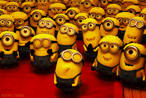 a bunch of minions with googly eyes are standing in a line