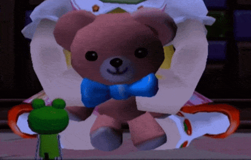 a teddy bear with a blue bow on its neck is being held by a green frog
