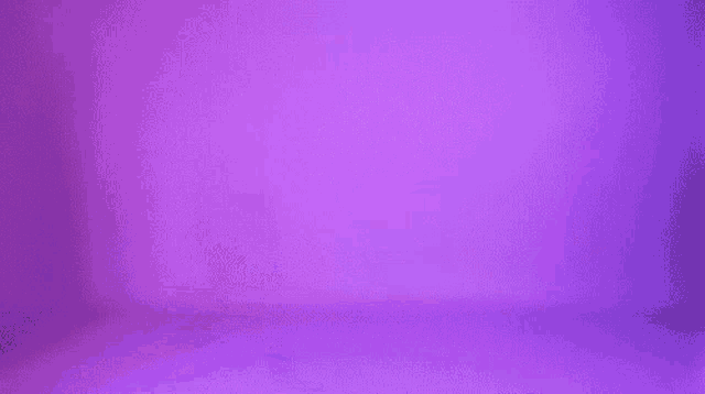 a woman in an orange jacket is walking on a purple background .