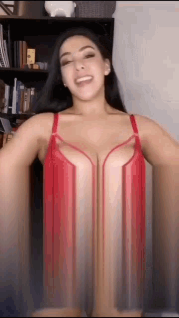 a woman is wearing a red bra and smiling .