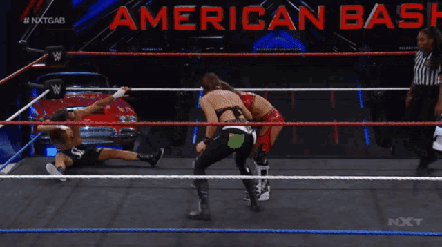 two wrestlers in a ring with a sign that says american bar