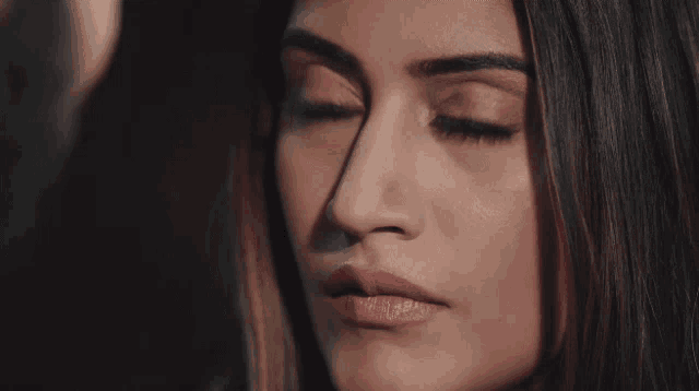 a close up of a woman 's face shows her red eyes