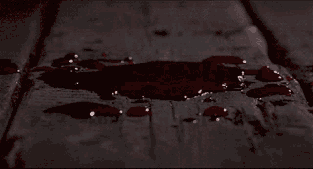 a puddle of blood on a wooden table