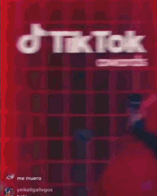 a man in a red jacket is standing next to a woman in front of a sign that says tik tok awards