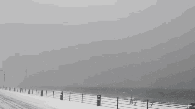 a snowy landscape with a yellow sign that says l
