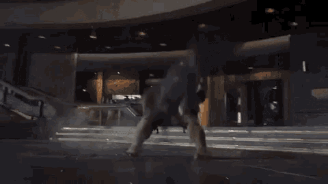 a hulk is breaking through a building with his arms and legs