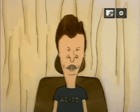 a cartoon of beavis and butthead wearing a black ac dc shirt is sitting on a couch .