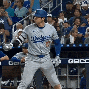 a dodgers baseball player is getting ready to bat in front of a crowd