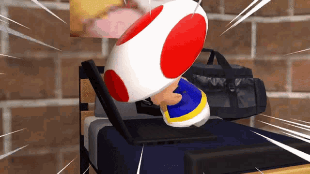 a video game character is laying on a bed with a laptop