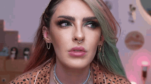a woman with green hair and a nose ring