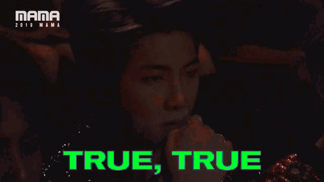 a woman sitting in a crowd with the words true true on the bottom