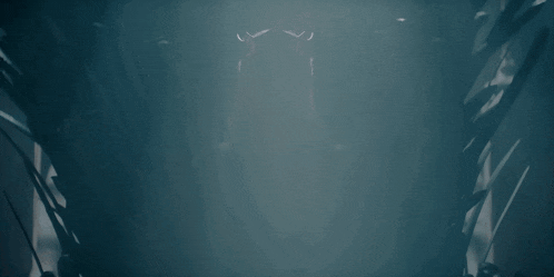 a dark room with a light coming out of the ceiling