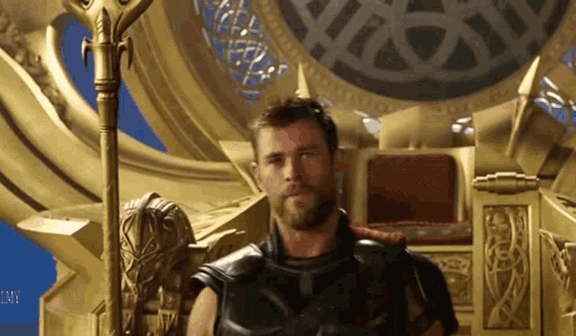 a man with a beard is sitting on a throne with his arm around another man 's shoulder