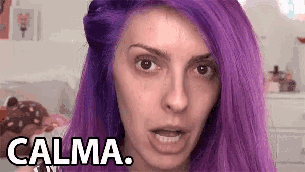 a woman with purple hair is making a funny face and the word calma is above her