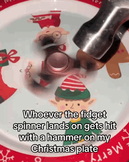 a fidget spinner on a christmas plate with a hammer