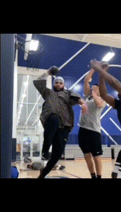 a group of people are playing a game of basketball