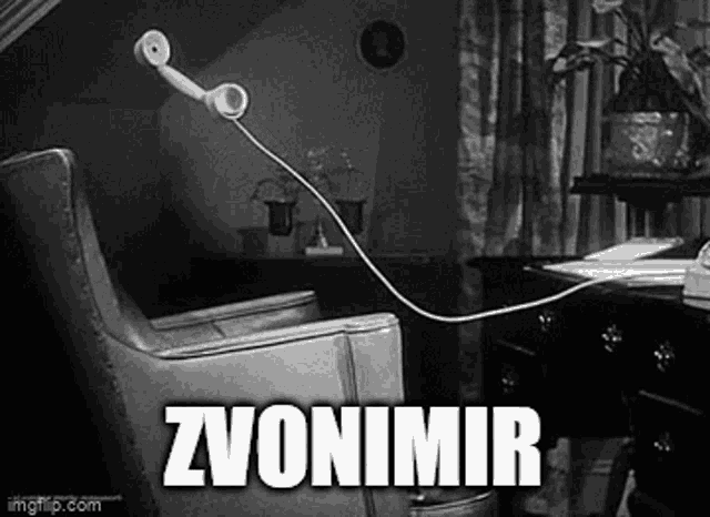 a black and white photo of a chair with a telephone plugged into it .