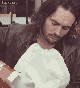 a man with long hair and a beard is eating a bag of food