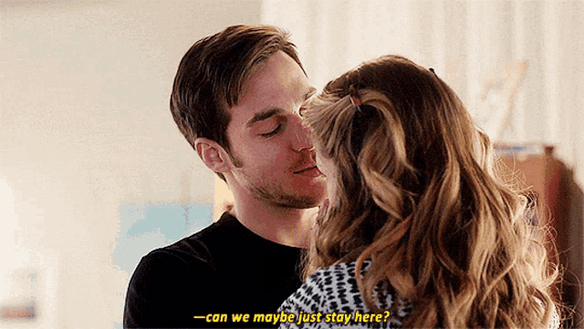 a man and a woman are kissing and the man is asking if they can just stay here