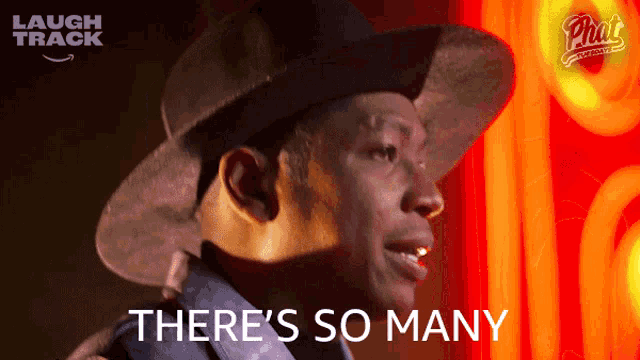 a man in a hat says there 's so many in front of a neon sign