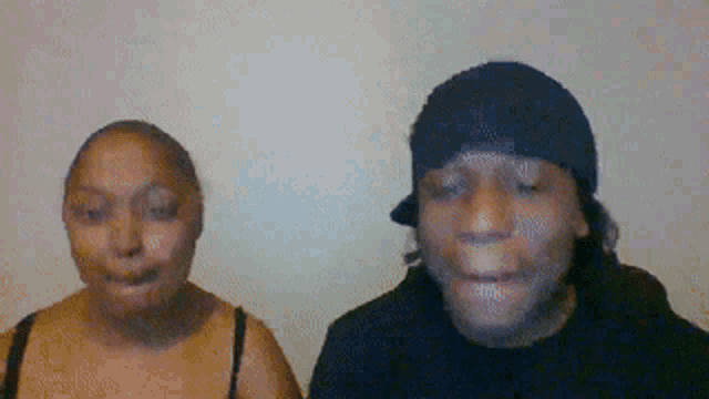 a man and a woman are standing next to each other with their mouths open