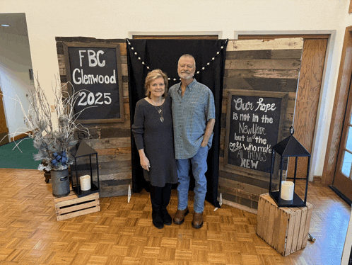 a man and a woman stand in front of a sign that says fbc glenwood 2025
