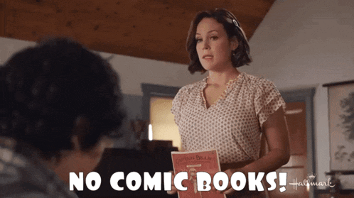 a woman is holding a book that says no comic books on it