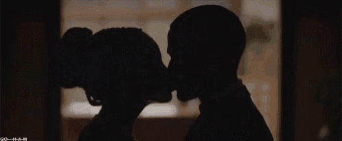 a man and a woman are looking at each other and kissing .