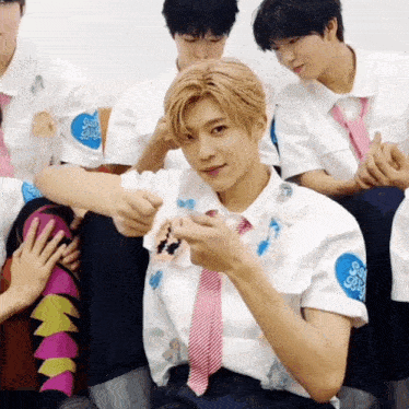 a boy wearing a white shirt with a sticker on it that says ' sss ' on it