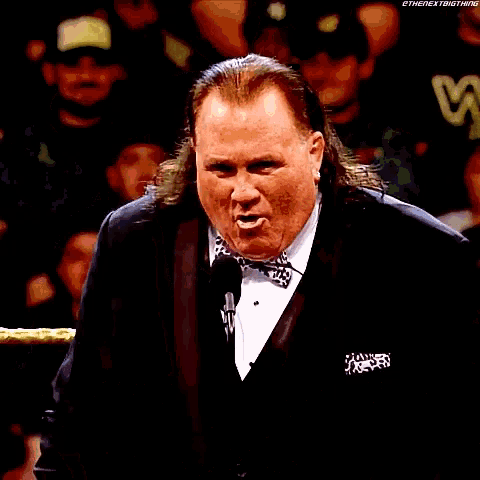 a man in a tuxedo is giving a speech in front of the hall of fame