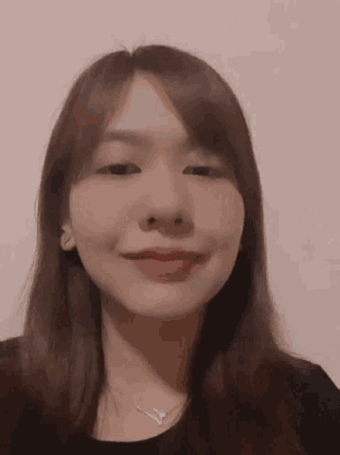 a close up of a woman 's face with a pink background