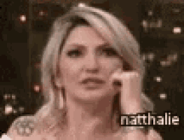 a close up of a woman 's face with the name nathalie written on the bottom .