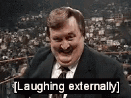 a man in a suit and tie is laughing outside .